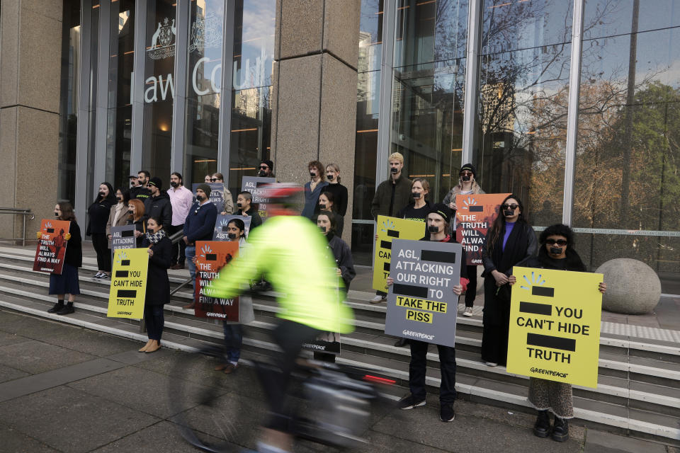 Greenpeace supporters demonstrate outside the Federal Court in Sydney, Wednesday, June 2, 2021. Australia's largest electricity generator AGL Energy is taking Greenpeace to court alleging breaches of copyright and trademark laws in the environmental charity's campaign that describes AGL as the nation's "biggest climate polluter." (AP Photo/Rick Rycroft)