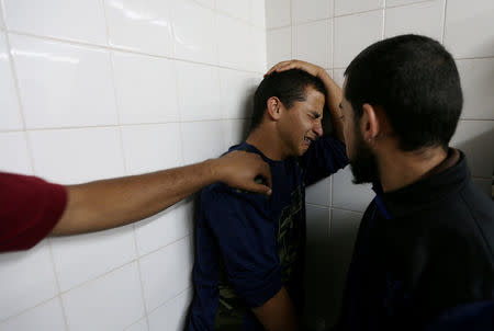 A relative of a Palestinian who was killed at the Israel-Gaza border reacts at a hospital, in the southern Gaza Strip May 6, 2018. REUTERS/Ibraheem Abu Mustafa