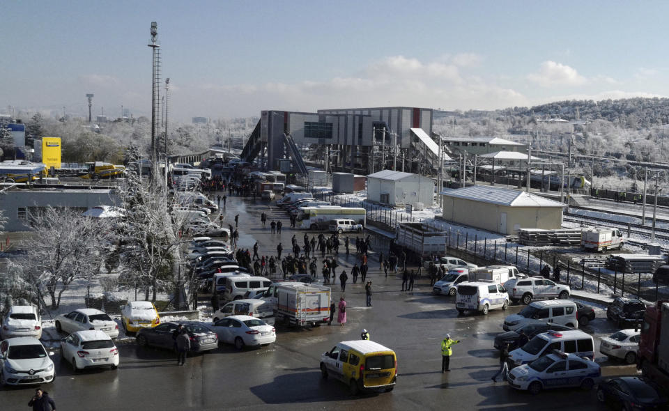 Police officers attend as members of rescue services work at the scene of a train accident, rear, in Ankara, Turkey, Thursday, Dec. 13, 2018. A high-speed train hit a railway engine and crashed into a pedestrian overpass at a station in the Turkish capital Ankara on Thursday, killing more than 5 people and injuring more than 40 others, officials and news reports said. (AP Photo/Burhan Ozbilici)