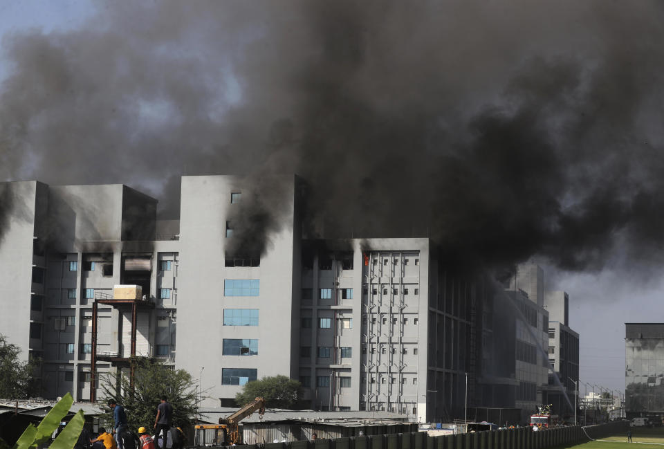 Firemen try to douse a fire at Serum Institute of India, the world's largest vaccine maker that is manufacturing the AstraZeneca/Oxford University vaccine for the coronavirus, in Pune, India, Thursday, Jan. 21, 2021. (AP Photo/Rafiq Maqbool)