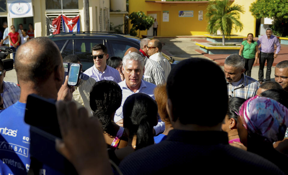 Cuba's President Miguel Diaz-Canel visits with residents after arriving in Caimanera, Cuba, Thursday, Nov. 14, 2019. Díaz-Canel is making his first trip to the town of Caimanera, the closest point in Cuba to the U.S. naval base at Guantanamo Bay. He arrived on Thursday morning. ( AP Photo/Ismael Francisco)