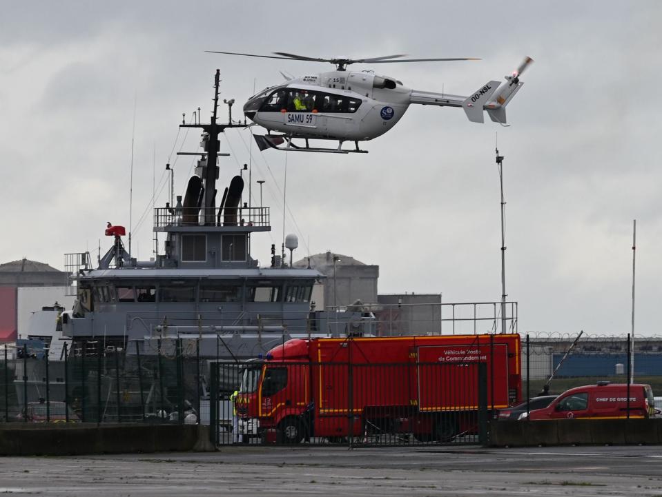 A SAMU (French Urgent Medical Aid Service) helicopter landing at Dunkerque port, northern France amid a rescue operation after a migrant boat sank on 27 October  (AFP via Getty Images)