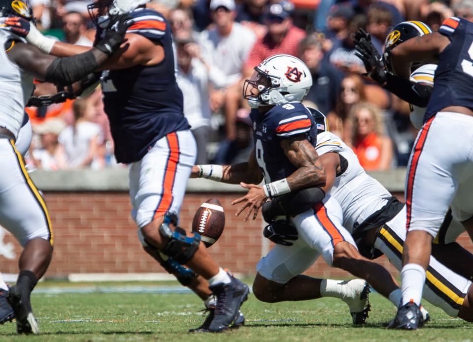 Auburn Tigers quarterback Robby Ashford (9) fumbles as he is sacked by Missouri Tigers defensive lineman Isaiah McGuire (9) as Auburn Tigers take on Missouri Tigers at Jordan-Hare Stadium in Auburn, Ala., on Saturday, Sept. 24, 2022. 