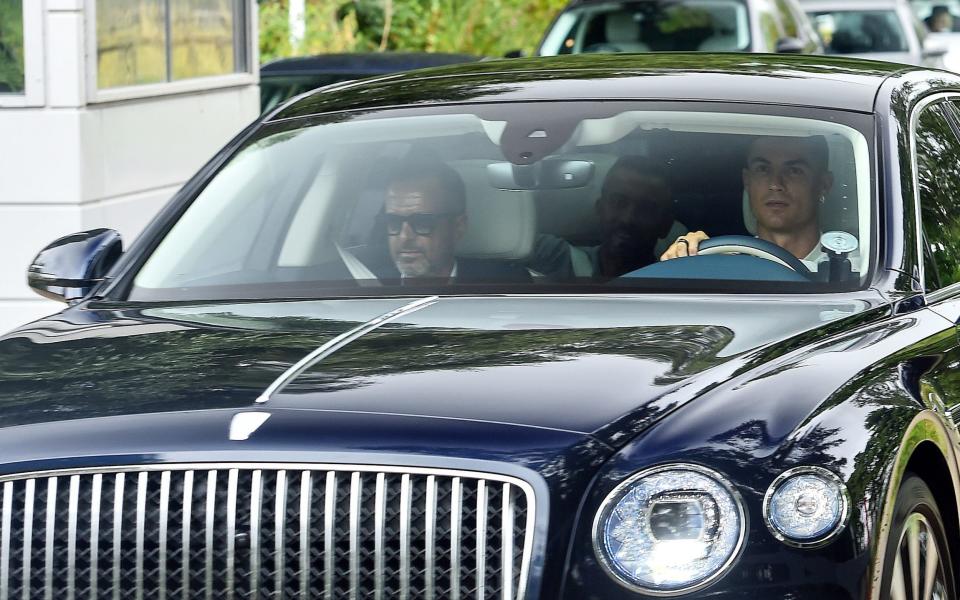 Ronaldo and his agent, Jorge Mendes, arrive at the Carrington training ground for the showdown talks - PA