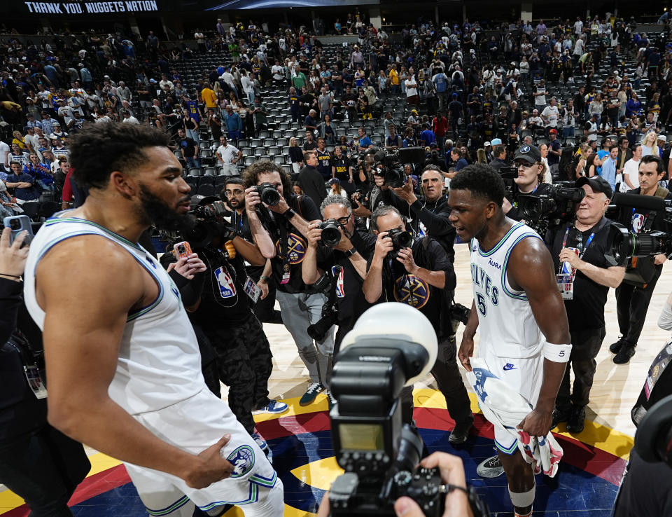 Minnesota Timberwolves center Karl-Anthony Towns, left center, celebrates with guard Anthony Edwards, right center, after Game 7 of an NBA second-round playoff series against the Denver Nuggets Sunday, May 19, 2024, in Denver. (AP Photo/David Zalubowski)