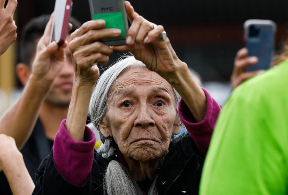 <p>A woman takes a photo as Pope Francis meets with First Nations, Metis and Inuit indigenous communities in Maskwacis, Alberta, Canada July 25, 2022. REUTERS/Amber Bracken</p> 