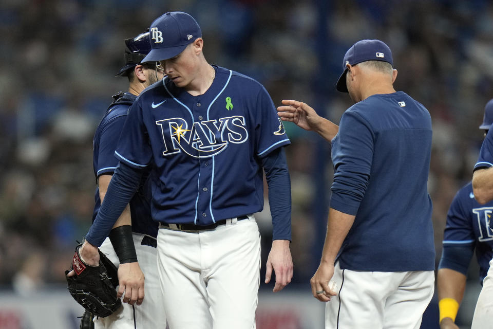 Tampa Bay Rays pitcher Ryan Yarbrough, left, gets taken out of the game against the New York Yankees by manager Kevin Cash during the sixth inning of a baseball game Thursday, May 26, 2022, in St. Petersburg, Fla. (AP Photo/Chris O'Meara)