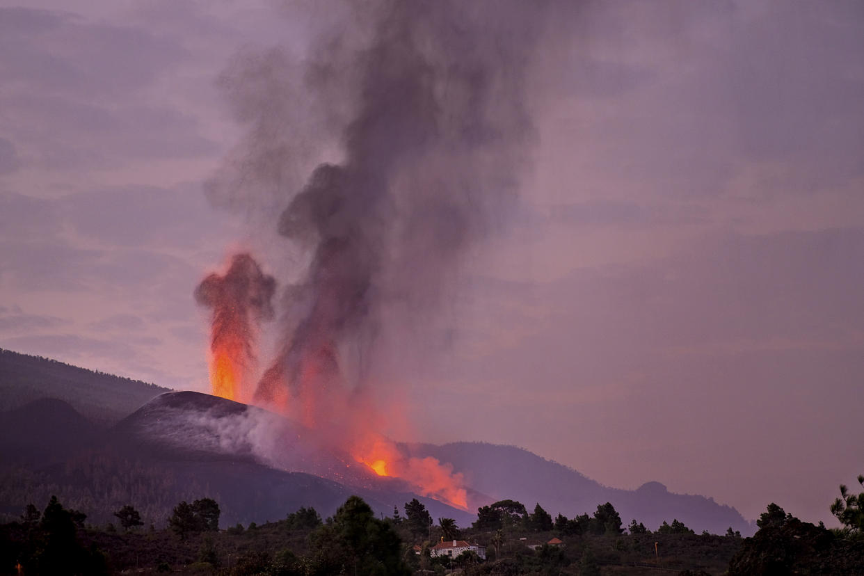 Lava flows from a volcano on the Canary island of La Palma, Spain on Friday Oct. 1, 2021. An erupting volcano on a Spanish island off northwest Africa has blown open another fissure on its hillside. Authorities were watching Friday to see whether lava from the new fissure would join the main flow that has reached the sea. The new fissure is the third to crack open since the Cumbre Vieja crater erupted on La Palma island Sept. 19. (AP Photo/Daniel Roca)