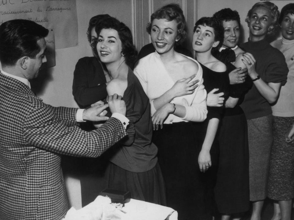Models line up for their smallpox vaccinations on 2nd October 1955.