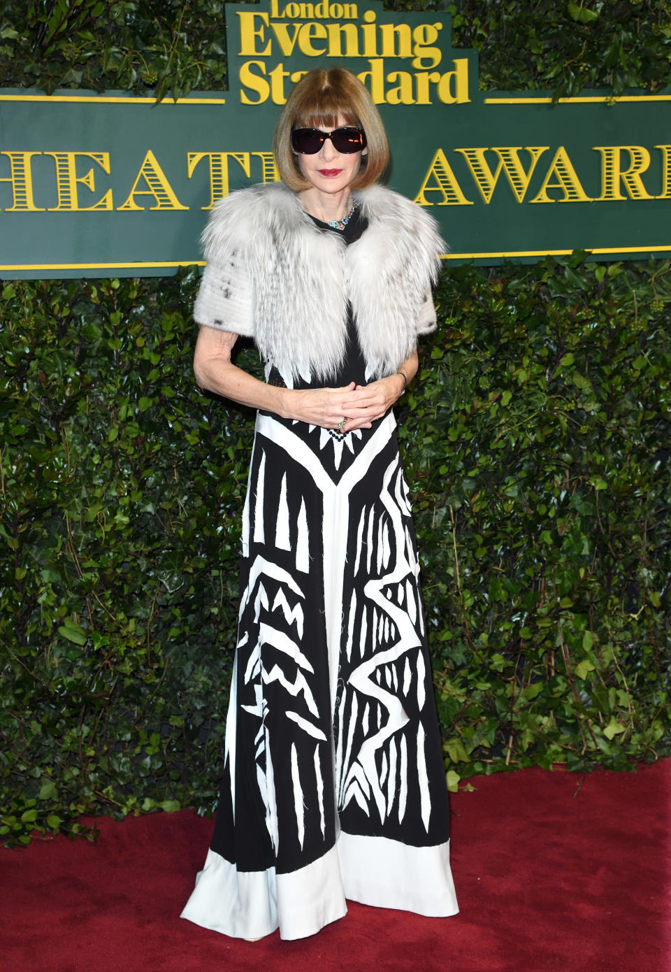 <p>The legendary <i>Vogue</i> editor kept her trademark sunglasses on, pairing them with a monochrome couture gown by Maison Margiela. <i>[Photo: Getty]</i> </p>