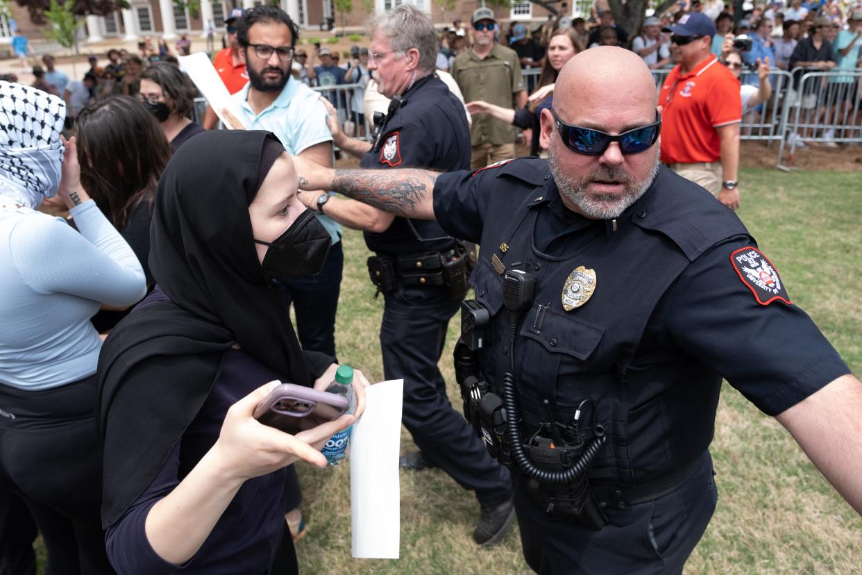 A University of Mississippi police lieutenant gestures for Jackie Stewart-Kuhn to move off the quad in front of the J.D. Williams Library on the University of Mississippi campus in Oxford on Thursday.