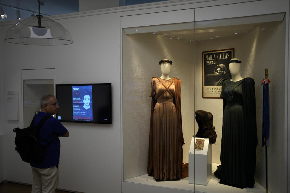 A man looks dresses of Greek Soprano Maria Callas at the newly established Museum, the first dedicated to the legendary opera star, in Athens, Greece, Wednesday, Oct. 25, 2023. The new museum presents, priceless historical artifacts, including photographs and portraits, rare live recordings, and a unique collection of records and personal items as this year is the 100th anniversary of Maria Callas' birth. (AP Photo/Thanassis Stavrakis)