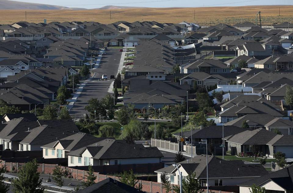 A neighborhood filled with built homes stretches towards the boundary with Interstate 82 off the Bob Olson Parkway in south Kennewick .