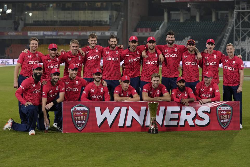 England's players pose for photograph with the trophy of twenty20 series, on the end of the seventh twenty20 cricket match between Pakistan and England, in Lahore, Pakistan, Sunday, Oct. 2, 2022. (AP Photo/K.M. Chaudary)