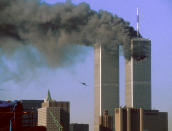 Hijacked United Airlines Flight 175 (L) flies toward the World Trade Center twin towers shortly before slamming into the south tower (L) as the north tower burns following an earlier attack by a hijacked airliner in New York City September 11, 2001. The stunning aerial assaults on the huge commercial complex where more than 40,000 people worked on an ordinary day were part of a coordinated attack aimed at the nation's financial heart. They destroyed one of America's most dramatic symbols of power and financial strength and left New York reeling. <br><br>(REUTERS/STR New)<a href="http://www.life.com/gallery/59971/911-the-25-most-powerful-photos#index/0" rel="nofollow noopener" target="_blank" data-ylk="slk:;elm:context_link;itc:0;sec:content-canvas" class="link "><br></a>