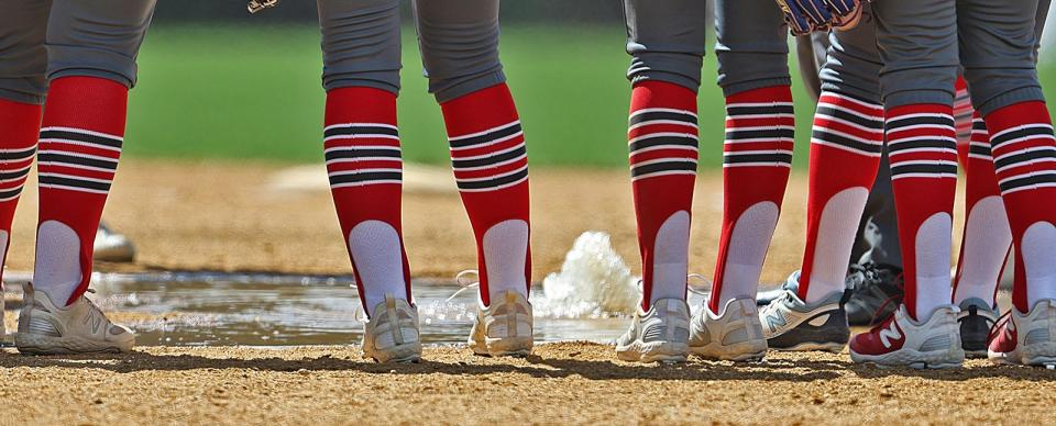 Silver Lake softball players gather around a fountain of water that sprung up inside the pitching circle. Silver Lake softball hosts Lincoln-Sudbury on Wednesday, April 17, 2024.