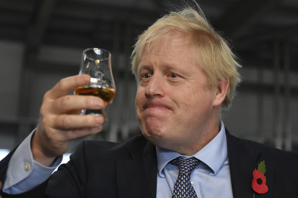 Britain's Prime Minister Boris Johnson tastes whisky during a general election campaign visit to Diageo's Roseisle Distillery near Elgin, north east Scotland, Thursday Nov. 7, 2019. Prime Minister Boris Johnson told British voters Wednesday that they have to back his Conservatives if they want an end to Brexit delays, as he tried to shake off a rocky start to the governing party's election campaign. (Daniel Leal-Olivas/Pool via AP)