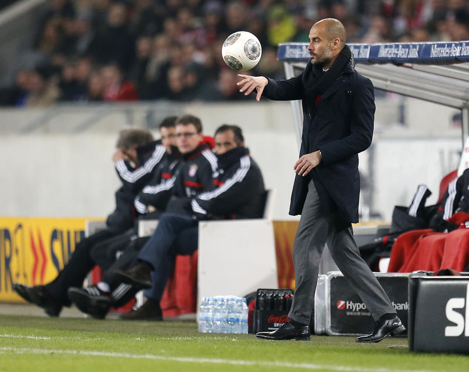 Bayern head coach Pep Guardiola of Spain carries a ball during a German first soccer division Bundesliga match between VfB Stuttgart and FC Bayern Munich in Stuttgart, Germany, Wednesday, Jan. 29, 2014. (AP Photo/Michael Probst)