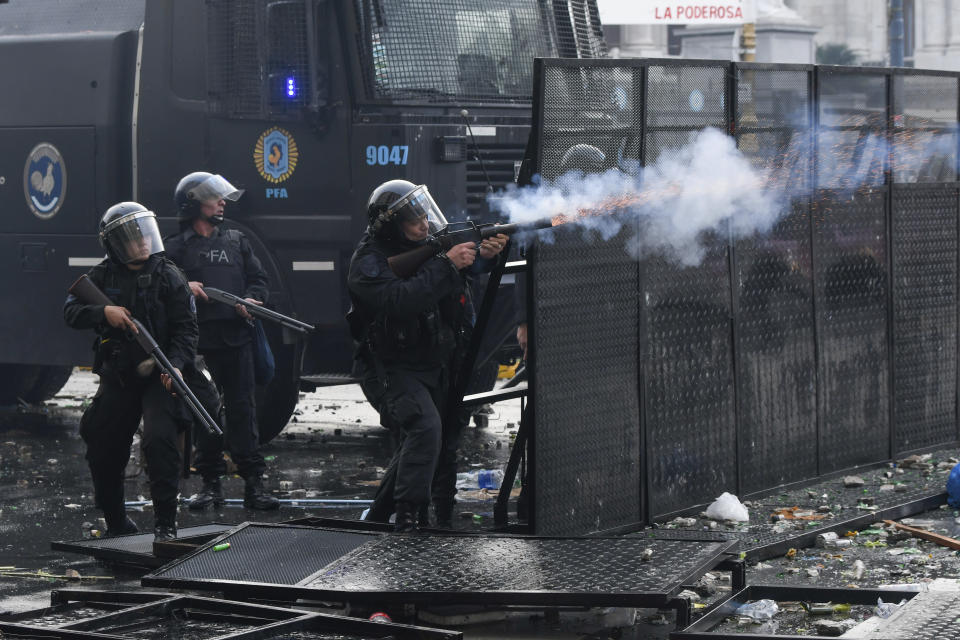 Police launch gas during clashes with anti-government protesters outside Congress, where lawmakers debate a reform bill promoted by Argentine President Javier Milei in Buenos Aires, Argentina, Wednesday, June 12, 2024. (AP Photo/Gustavo Garello)