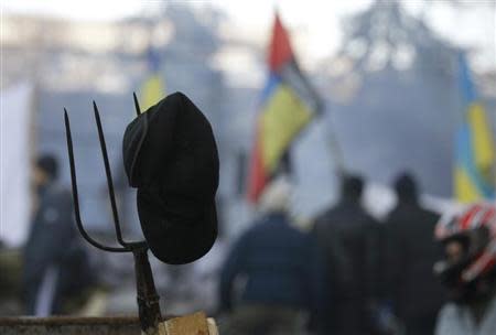 A pitchfork is seen behind anti-government protesters at the barricades in Kiev February 4, 2014. REUTERS/Vasily Fedosenko