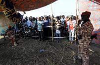 FILE PHOTO: Sudanese military officers keep guard as Ethiopians who fled war in Tigray region, gather to receive relief supplies from the World Food Programme at the Fashaga camp on the Sudan-Ethiopia border in Al-Qadarif state