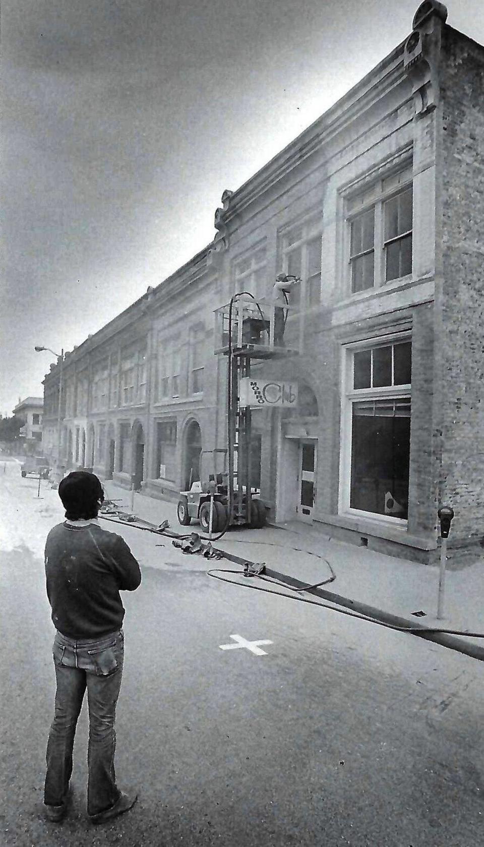 Vincent Fonte, left, watches partner Al McVay sandblast outside of historic Andrews Bank building. Work was being done by the building’s new owners. Sign for the Morro Club is under workman. The Osos Street side of the Andrews Bank building was being sand blasted to remove paint May 7, 1974.