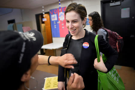 A voter gets an "I voted" sticker after casting her ballot in the Pennsylvania primary at a polling place in Philadelphia, Pennsylvania, U.S., April 26, 2016. REUTERS/Charles Mostoller