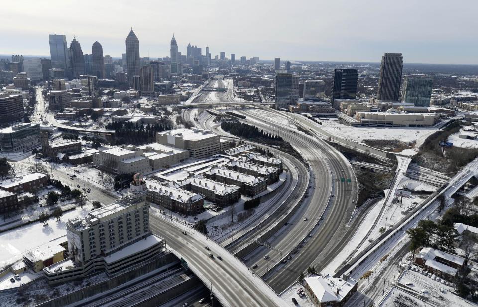 In this aerial view looking south toward downtown Atlanta, the ice-covered interstate system shows the remnants of a winter snow storm Wednesday, Jan. 29, 2014, in Atlanta. While such amounts of accumulation barely quality as a storm in the north, it was enough to paralyze the Deep South. (AP Photo/David Tulis)