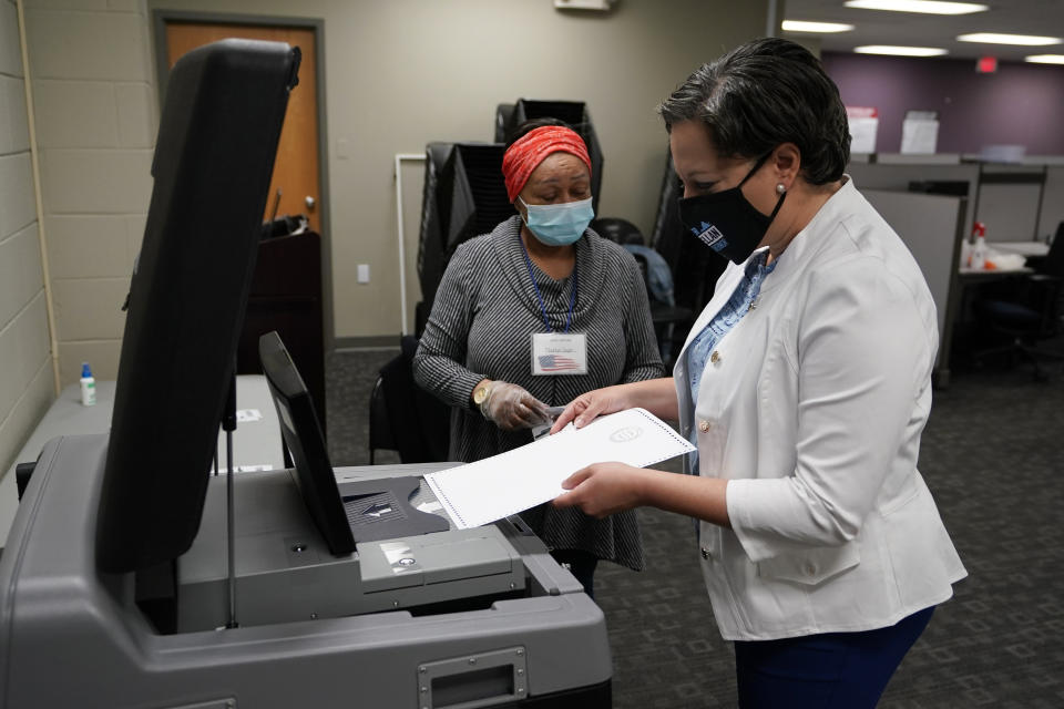 Democratic gubernatorial candidate, Virginia State Sen. Jennifer McClellan, inserts her ballot in a voting machine at an early voting location in Richmond, Va., Saturday, May 29, 2021. McClellan faces four other Democrats in the primary. (AP Photo/Steve Helber)