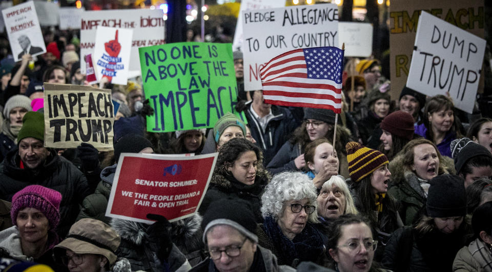 An anti-President Trump crowd gather at a rally to protest and call for his impeachment, Tuesday Dec. 17, 2019, in New York. (AP Photo/Bebeto Matthews)