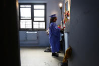 Maddison Washington, 11, stands at her bedroom mirror as she finishes getting ready for her virtual graduation from middle school on Friday, Aug. 21, 2020, in Brooklyn borough of New York. "Everybody else had a graduation, even her twin brother. ... And she has to have a virtual graduation," said Sharawn Vinson, Washington's mother. "So it makes you sit back and think, what is their life going to be like going forward, what's going to happen?" (AP Photo/Jessie Wardarski)