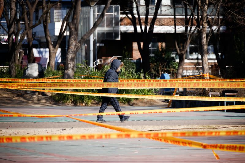 A man walks past a basketball court which has been cordoned off as part of a measure to avoid the spread of the coronavirus disease (COVID-19) at a park in Seoul