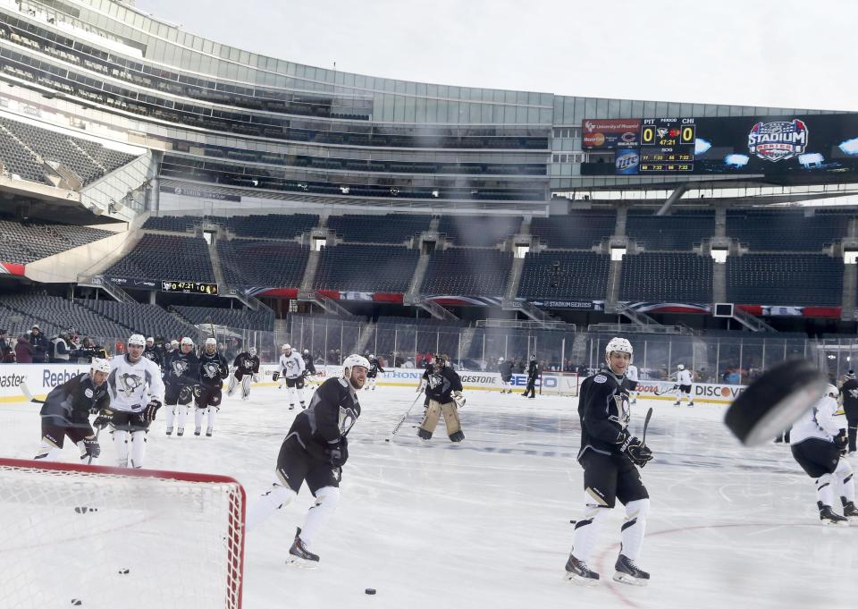 The Pittsburgh Penguins practice on the Soldier Field ice for Saturday's Stadium Series NHL hockey game between the Penguins and the Chicago Blackhawks, Friday, Feb. 28, 2014, in Chicago. (AP Photo/Charles Rex Arbogast)