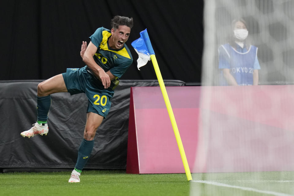 Australia's Lachlan Wales celebrates scoring his side's opening goal against Argentina during a men's soccer match at the 2020 Summer Olympics, Thursday, July 22, 2021, in Sapporo, Japan. (AP Photo/SIlvia Izquierdo)