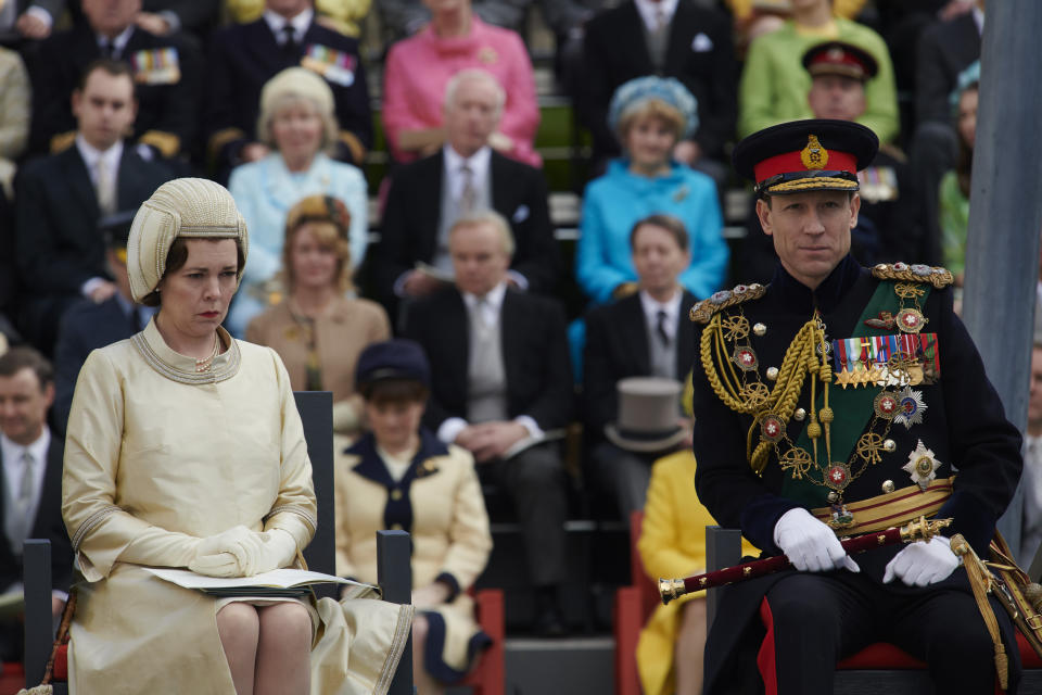 In this image released by Netflix, Olivia Colman plays Queen Elizabeth II and Tobias Menzies portrays Prince Philip in a scene from the third season of "The Crown." Britain's Prince Philip stood loyally behind behind Queen Elizabeth, as his character does on Netflix's “The Crown.” But how closely does the TV character match the real prince, who died Friday, April 9, 2021 at 99? Philip is depicted as a man of action in “The Crown,” and he served with distinction in the navy in World War II. He was also an avid yachtsman and polo player.(Des Willie/Netflix via AP)