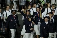 <p>Beach volleyball superstars Misty May-Treanor and Kerri Walsh Jennings show off Team USA's uniform in London's Opening Ceremony. (Getty) </p>