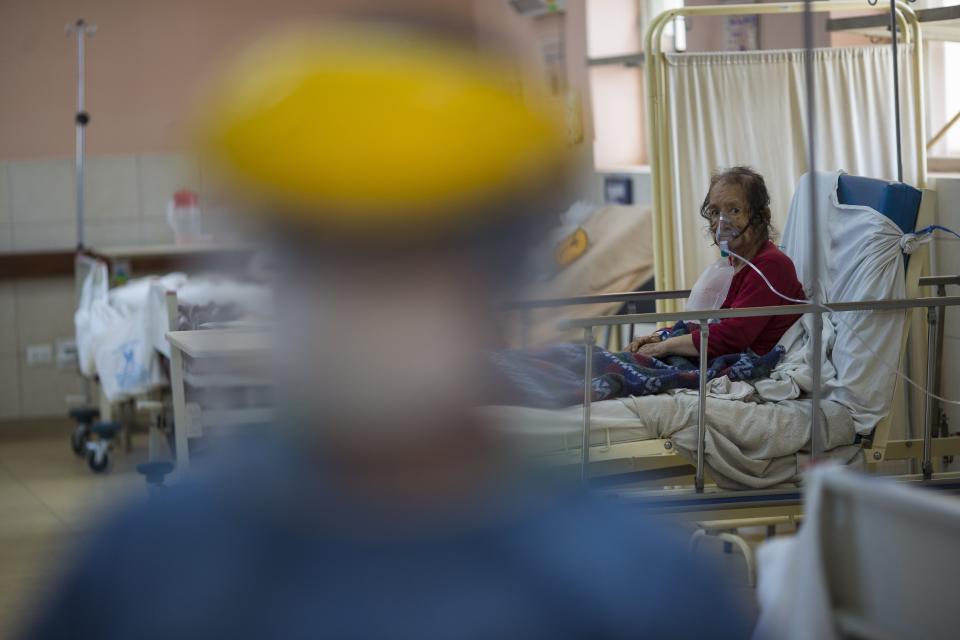 A patient using an oxygen mask rests inside the intensive care unit for people infected with the new coronavirus, at the 2 de Mayo Hospital, in Lima, Peru, Friday, April 17, 2020. (AP Photo/Rodrigo Abd)
