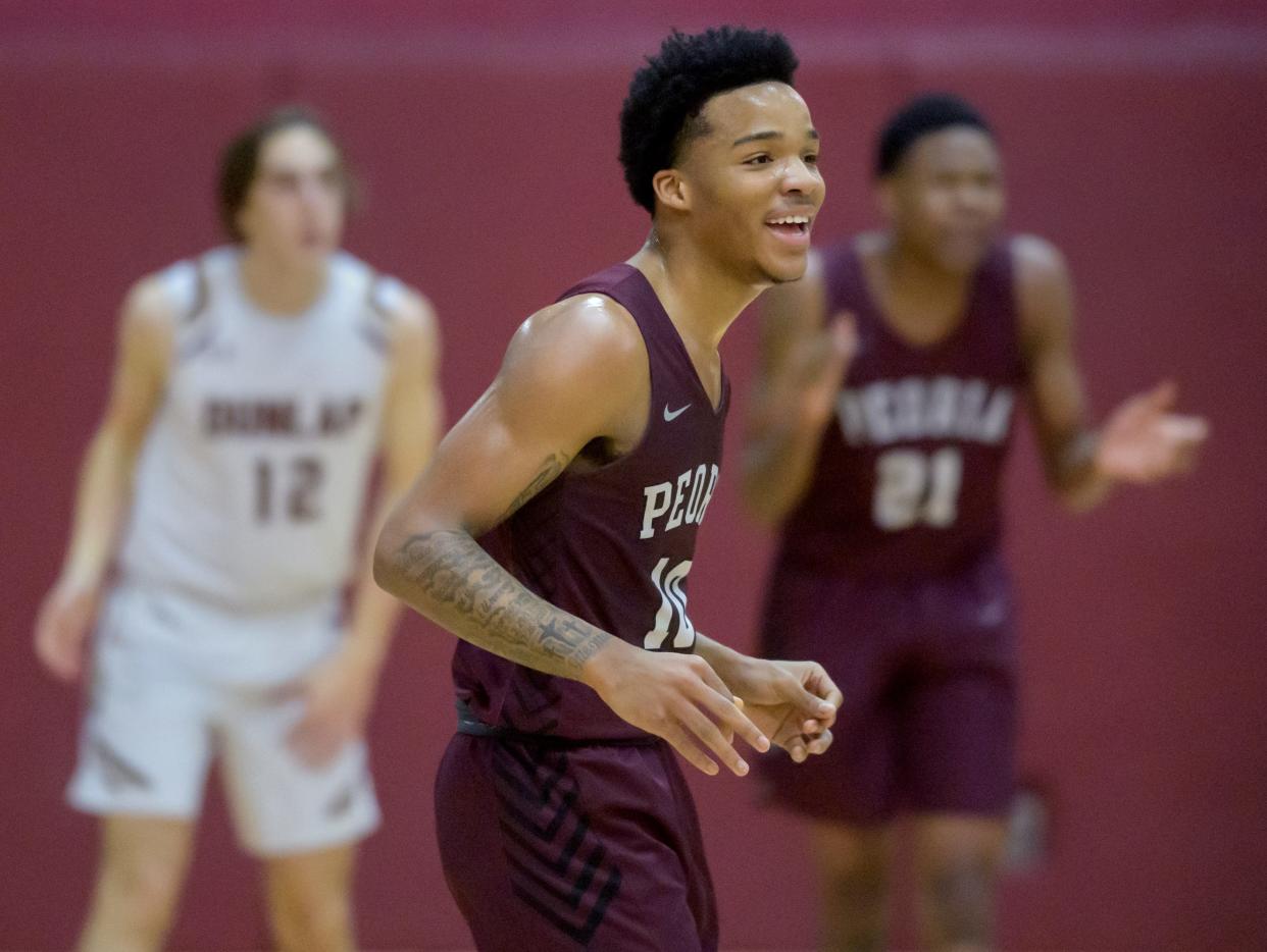 Peoria High's Mikequese Taylor (10) smiles as the Lions extend their lead agains Dunlap in the first half Tuesday, Jan. 17, 2023 at Dunlap High School. The Lions defeated the Eagles 71-46.