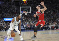 Minnesota Timberwolves guard Mike Conley (10) works toward the basket as Chicago Bulls guard Alex Caruso (6) defends during the second half of an NBA basketball game Sunday, March 31, 2024, in Minneapolis. (AP Photo/Abbie Parr)