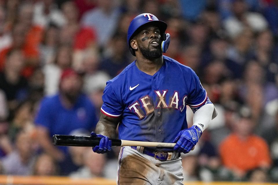 FILE - Texas Rangers' Adolis Garcia hits a home run during the third inning of Game 7 of the baseball AL Championship Series against the Houston Astros, Oct. 23, 2023, in Houston. All-Star catcher Jonah Heim and six other players have agreed to one-year contracts with the Rangers, but the World Series champions didn’t reach a deal with García. (AP Photo/David J. Phillip, File)