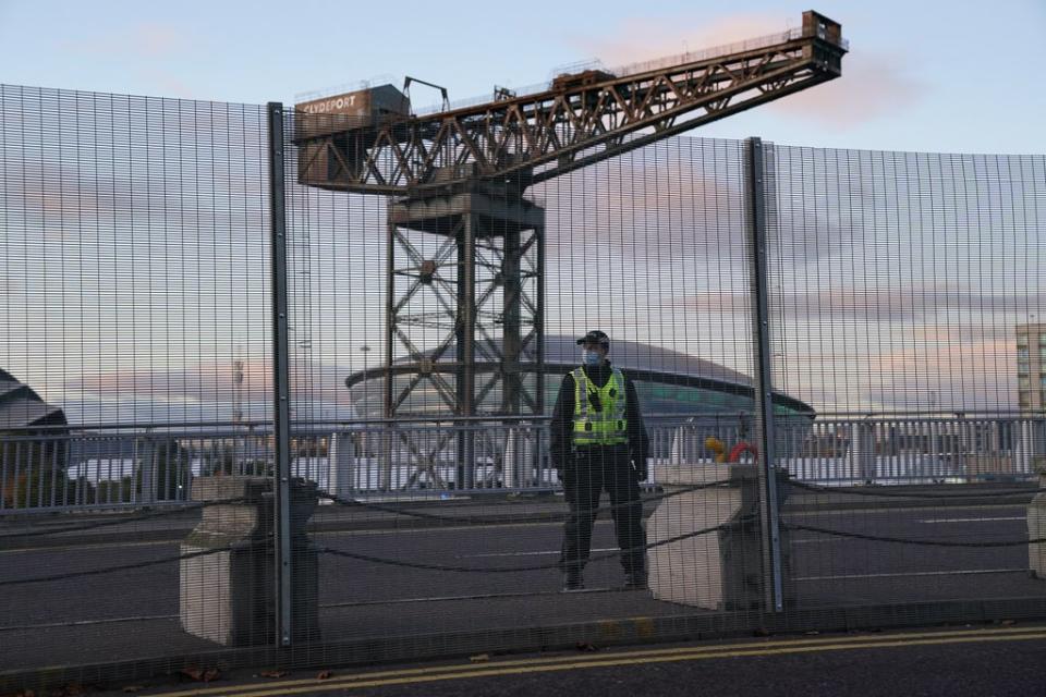 A police officer by the perimeter security fence of the Scottish Event Campus (SEC) in Glasgow (Andrew Milligan/PA) (PA Wire)