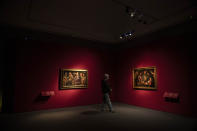 A visitor admires paints at the exhibition of French painter Georges de La Tour, during the reopening of Palazzo Reale, in Milan, Italy, Thursday, May 28, 2020. The Royal Palace in Milan reopened Thursday only by reservation, after the closure due to the coronavirus outbreak. (AP Photo/Luca Bruno)