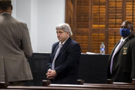 William "Roddie" Bryan, center, walks out of the jury selection room in handcuffs during jury selection for the trial at the Glynn County Courthouse, Monday, Oct. 25, 2021, in Brunswick, Ga. Bryan, Greg and Travis McMichael are charged with the slaying of 25-year-old Ahmaud Arbery in February 2020. (AP Photo/Stephen B. Morton, Pool)