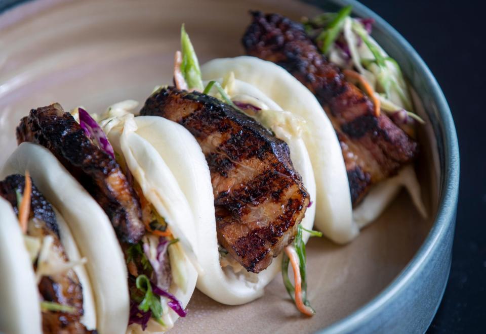 The bao bun, which includes slaw, miso aioli and pork belly cooked on a special Japanese robata grill at Modita on Thursday, April 1, 2021. The Asian-inspired Modita operates out of the Bottleworks facility in downtown Indianapolis and is one Cunningham Restaurant Group concepts likely to be represented in the upcoming CRG Delivery service.