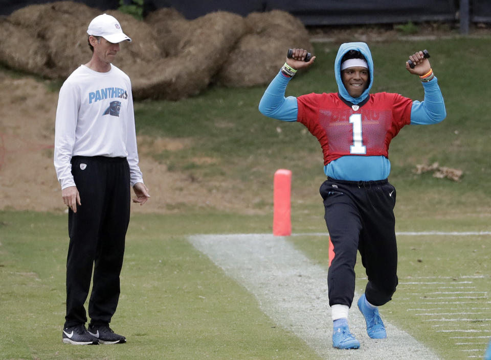 Carolina Panthers QB Cam Newton, right, works out last week under the watchful eyes of team trainer Ryan Vermillion. (AP)