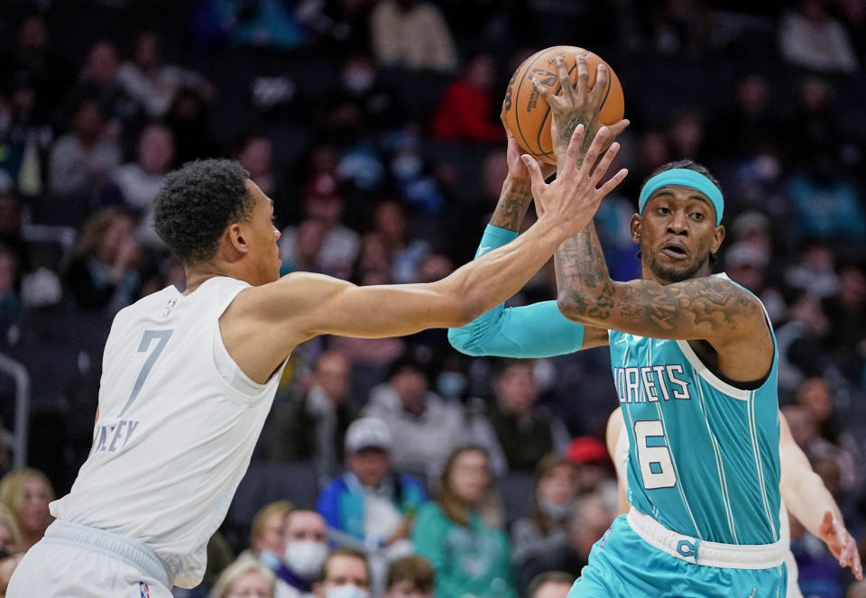 Charlotte Hornets forward Jalen McDaniels (6) is defended by Oklahoma City Thunder forward Darius Bazley (7) during the first half of an NBA basketball game Friday, Jan. 21, 2022, in Charlotte, N.C. (AP Photo/Rusty Jones)