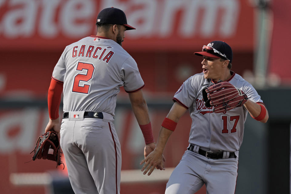 Washington Nationals' Luis Garcia (2) and Alex Call (17) celebrate after their baseball game against the Kansas City Royals Saturday, May 27, 2023, in Kansas City, Mo. The Nationals won 4-2. (AP Photo/Charlie Riedel)