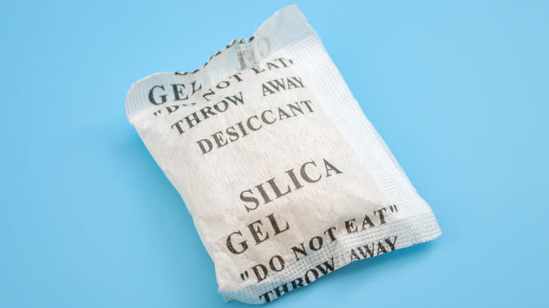 Silica gel packet on blue background