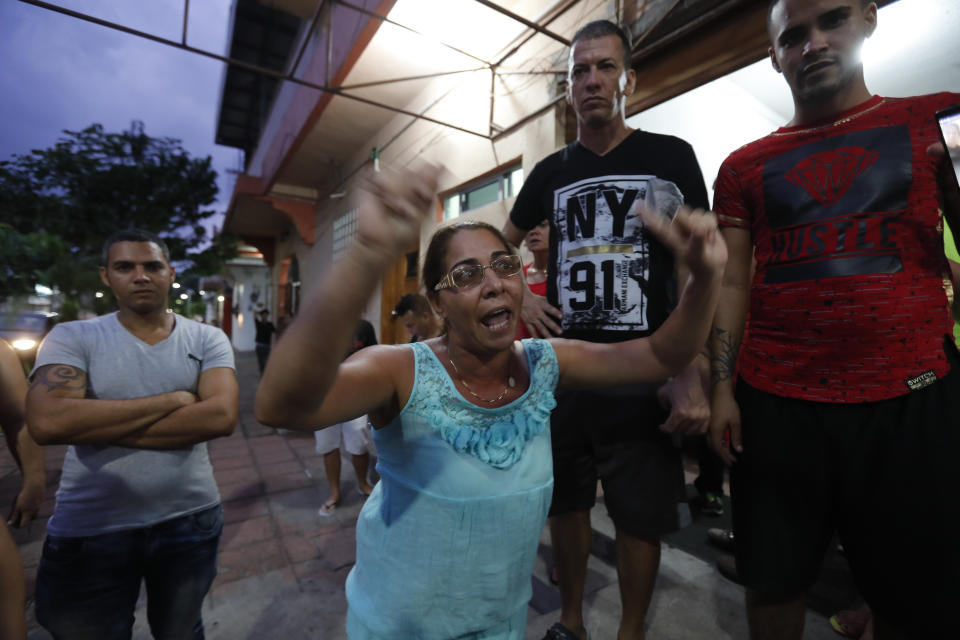 In this May 28, 2019 photo, Cuban migrants protest outside a hotel they were staying at, after raid by Mexican migration authorities in Tapachula, Chiapas state, Mexico. More than 600 migrants overwhelmed guards and fled Siglo XXI in April. According to several Cuban migrants they were blamed for a mass break out from the detention center and targeted for reprisals by authorities. (AP Photo/Marco Ugarte)