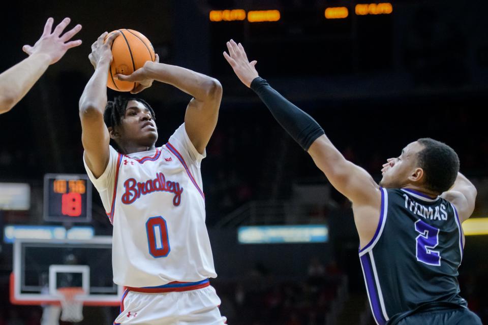 Bradley's Demarion Burch puts up a shot over Evansville's Antonio Thomas in the first half of their Missouri Valley Conference basketball game Wednesday, Jan. 10, 2024 at Carver Arena. The Braves routed the Purple Aces 86-50.